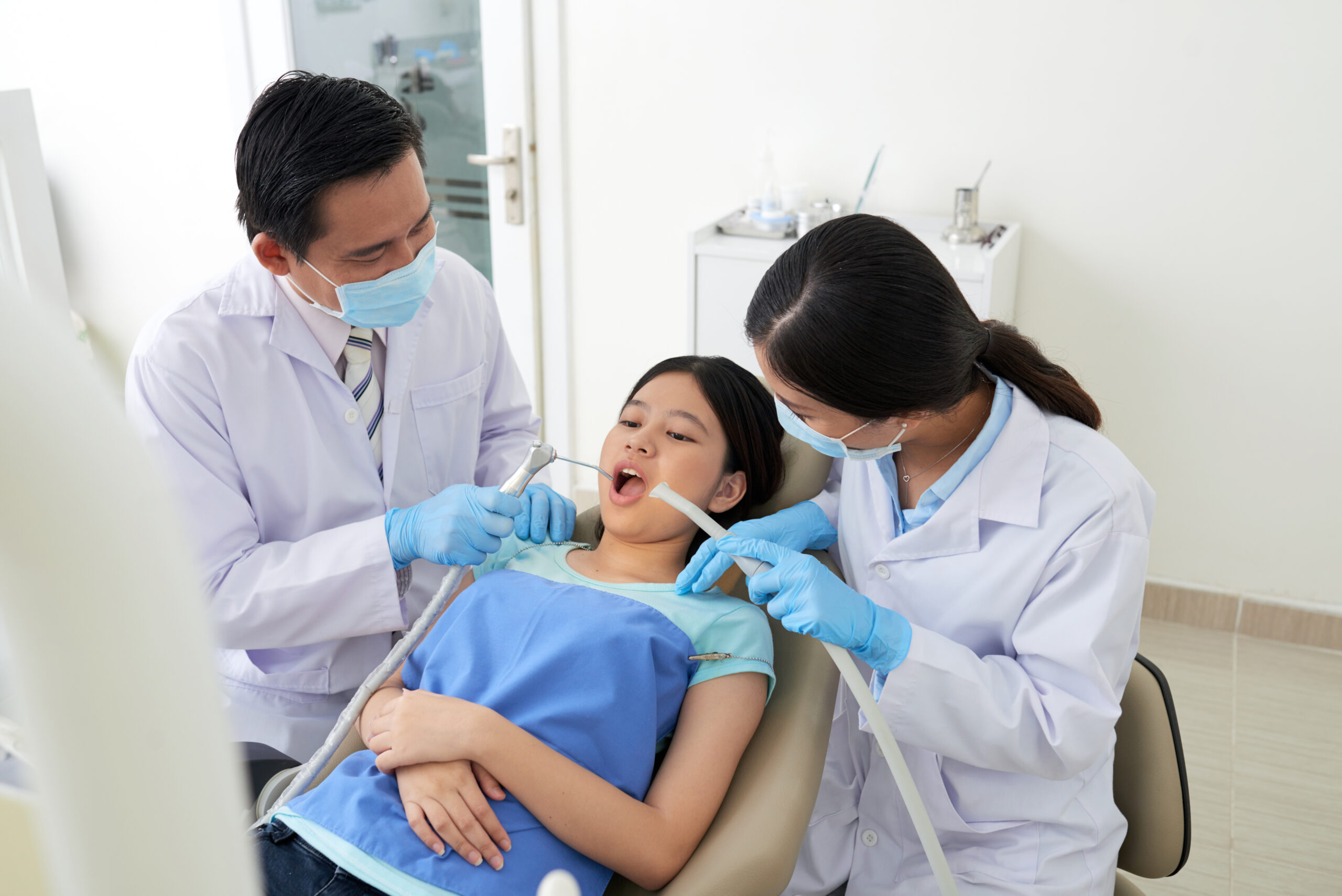 asian-male-dentist-female-nurse-treating-cavity-clinic-scaled