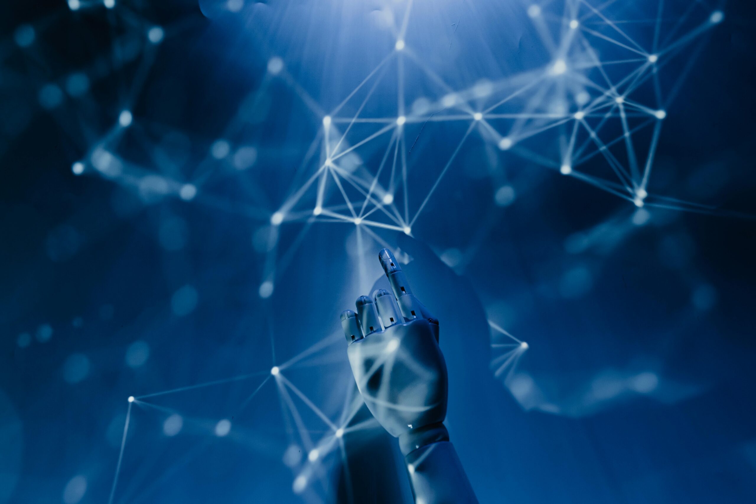 A robotic hand reaching toward a glowing digital network, representing AI and connectivity